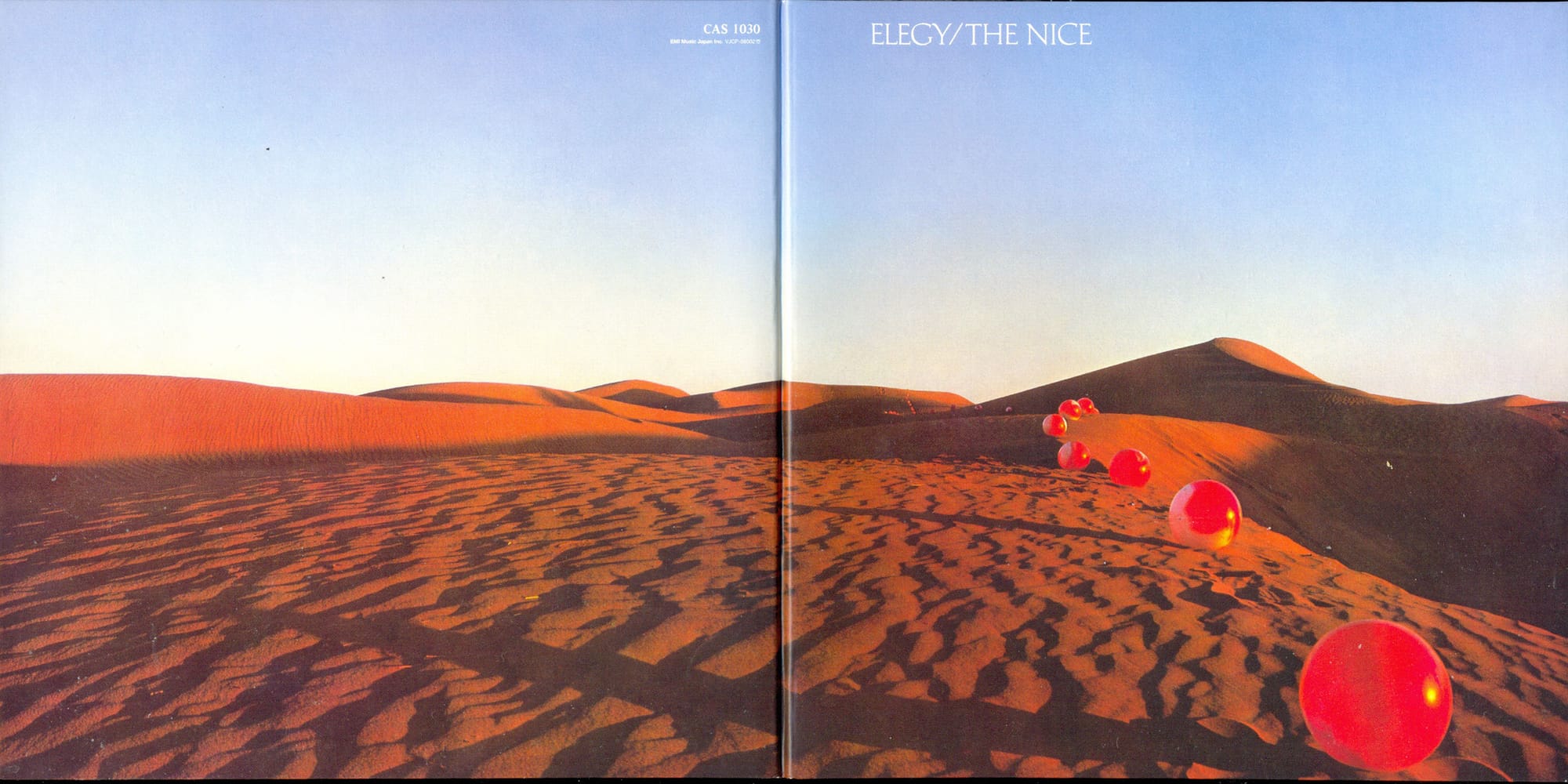 A full spread of an album cover with a photograph of red balls in a sandy desert and text in the sky "ELEGY/THE NICE"