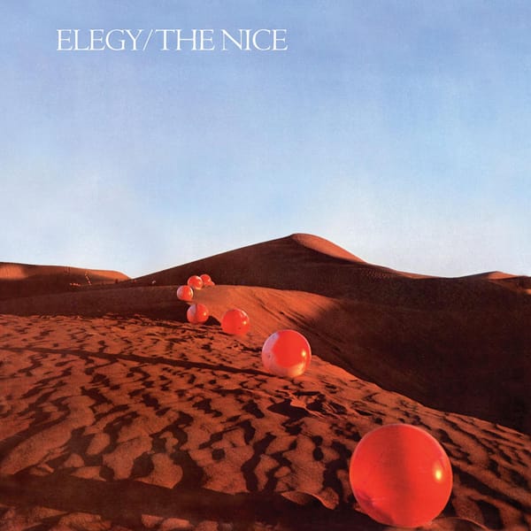 An album cover with a photograph of red balls in a sandy desert and text in the sky "ELEGY/THE NICE"